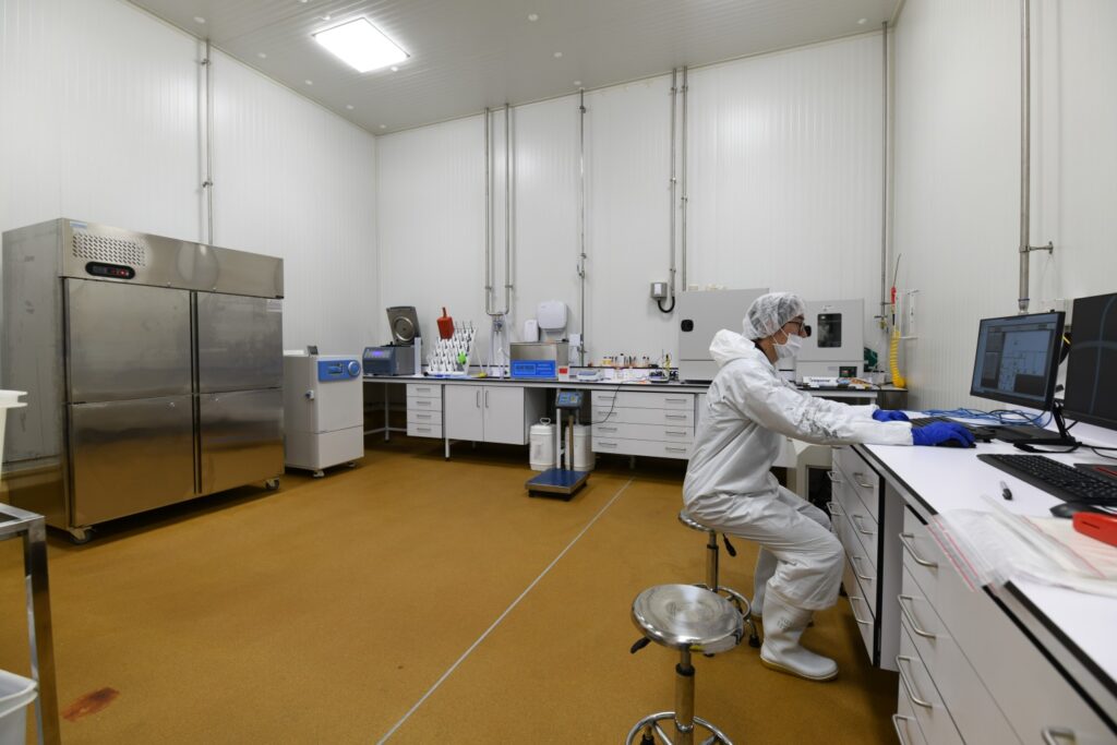 Scientist operating nutrient extraction system for Traditional Chinese Medicine sector